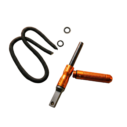 Complete inhoud verpakking oranje vuurstarter met draagkoord, ringen en de ferrocerium staaf